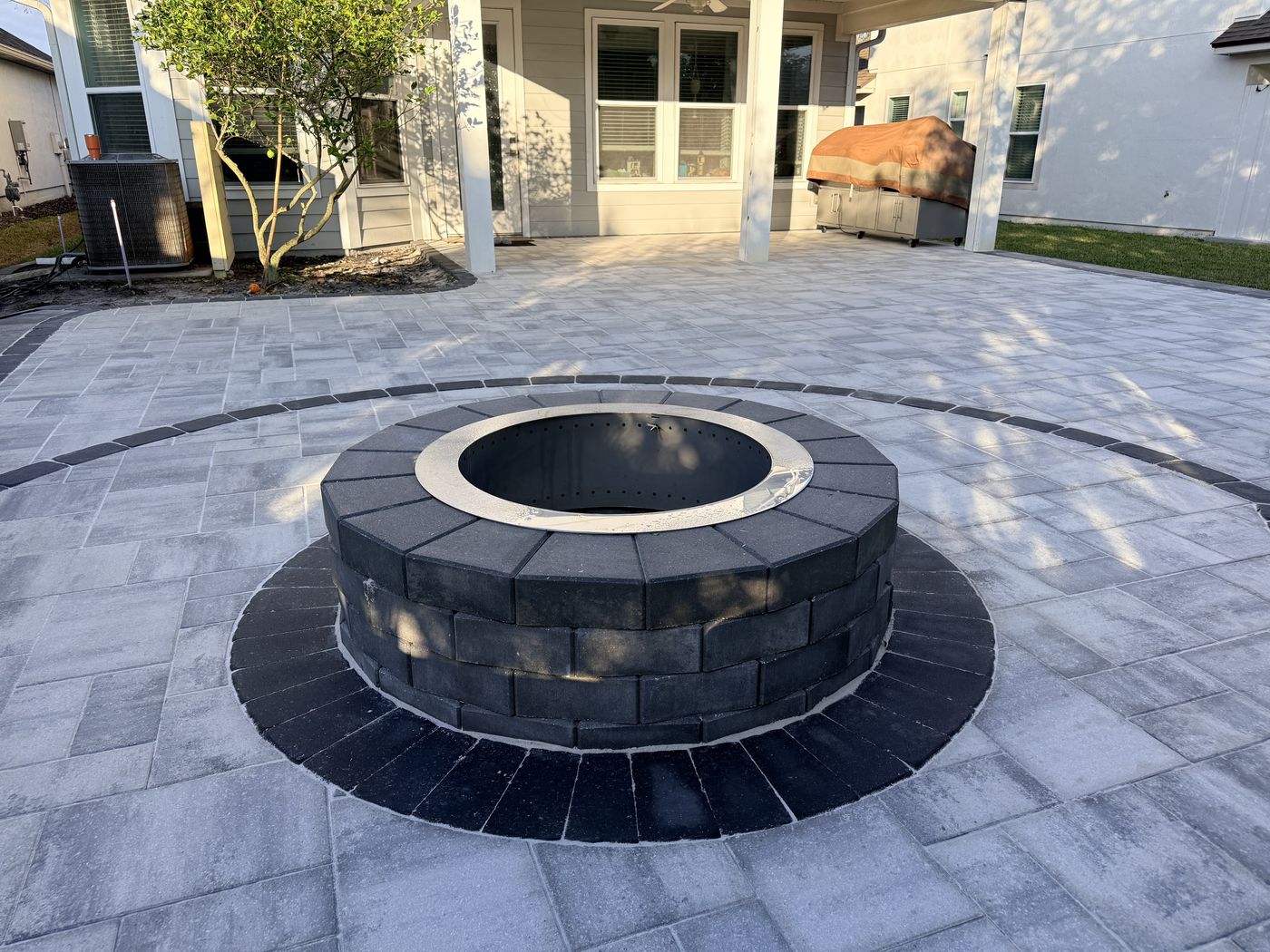 Custom paver firepit set into a wide paver patio, Nocatee FL